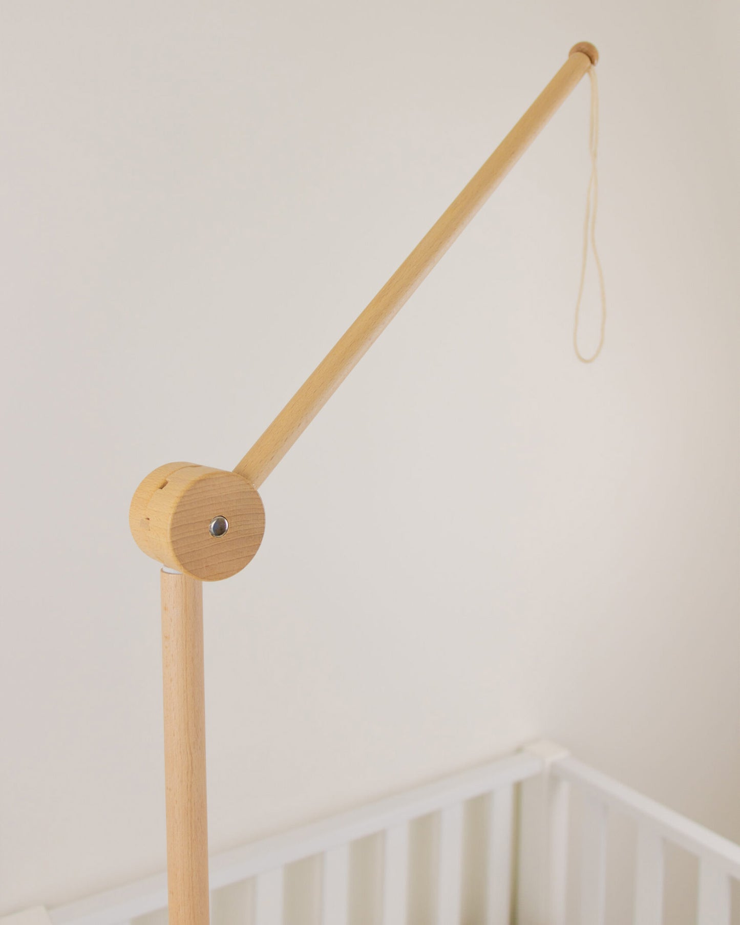 wooden arm attached to baby bed baby mobile